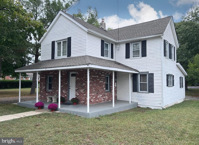 view of front of house featuring a front lawn and a patio area