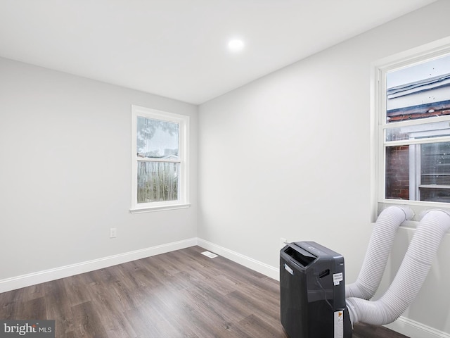 unfurnished room featuring dark hardwood / wood-style flooring