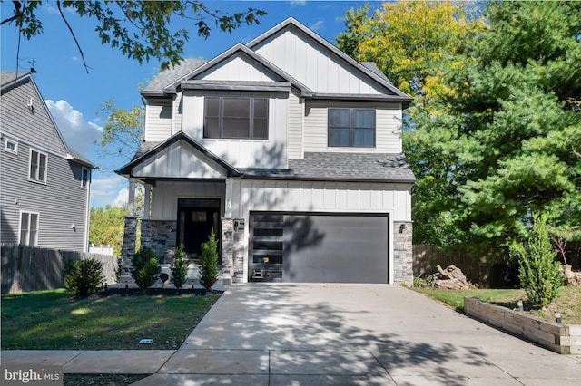 view of front of property featuring a garage and a front yard