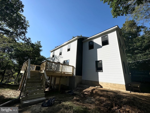 rear view of house with a wooden deck