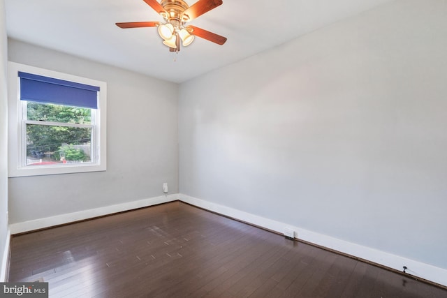 empty room featuring ceiling fan and dark wood-type flooring