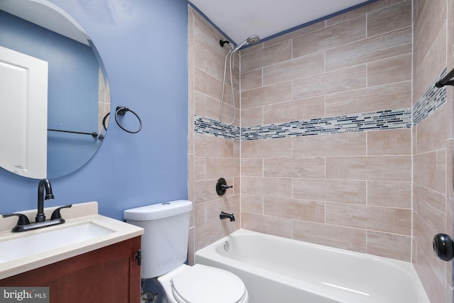 full bathroom featuring toilet, vanity, and tiled shower / bath