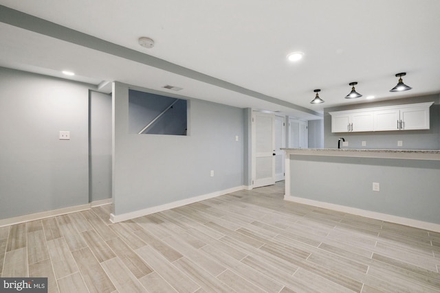 interior space featuring light wood-type flooring and sink