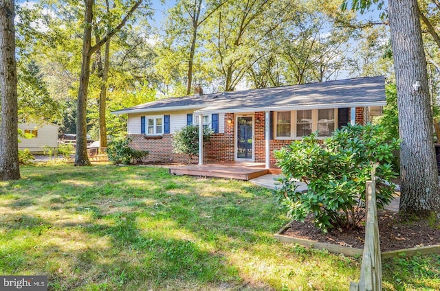 single story home featuring a front lawn and a deck