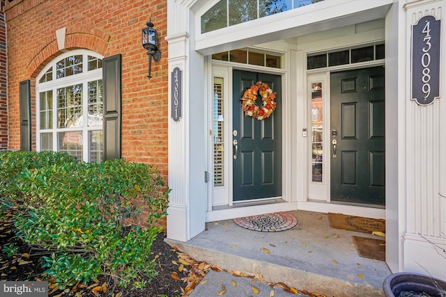 view of exterior entry featuring a porch