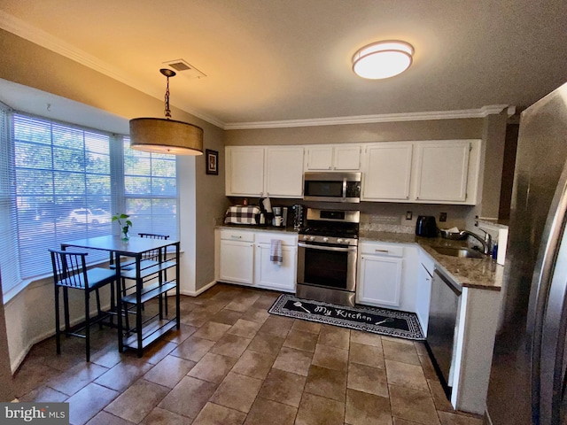 kitchen featuring decorative light fixtures, sink, appliances with stainless steel finishes, and white cabinets