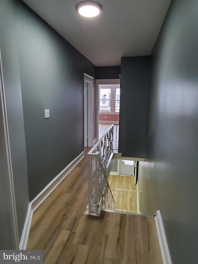 hallway with hardwood / wood-style floors