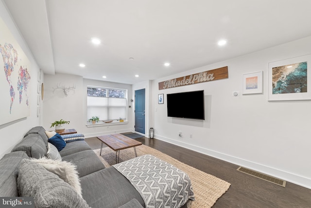 living room with dark hardwood / wood-style flooring