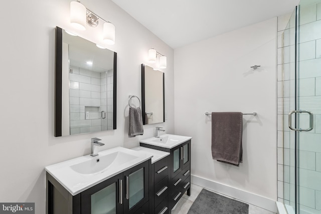 bathroom featuring walk in shower, vanity, and tile patterned flooring