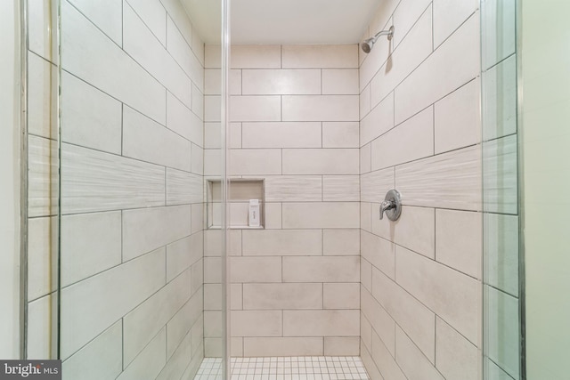 bathroom featuring a shower with door