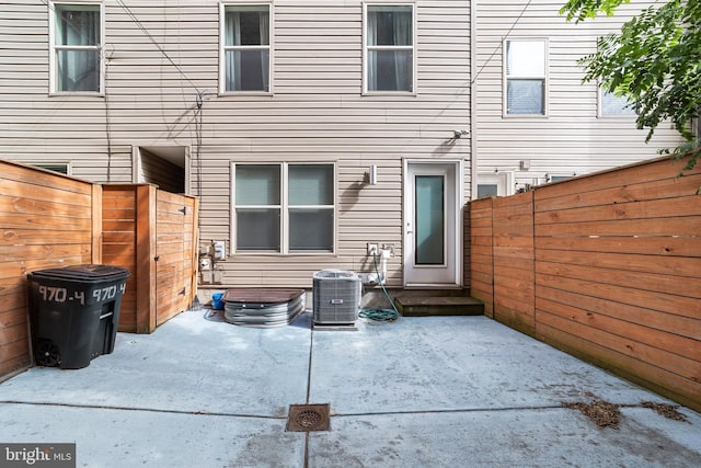 back of property featuring a patio and central AC