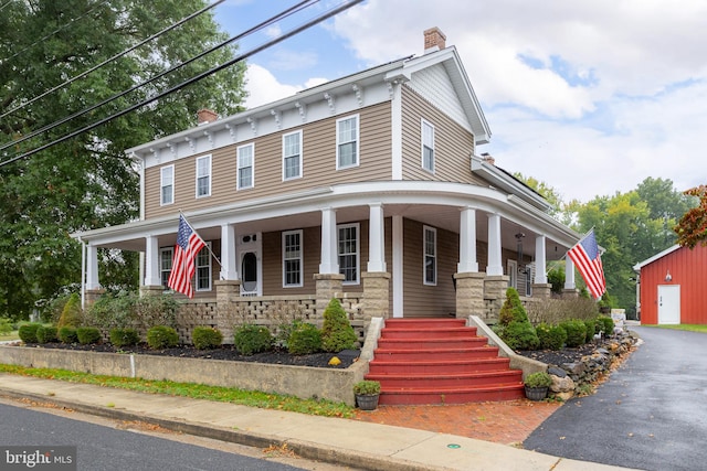 view of front facade with a garage and a porch