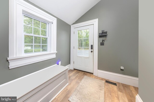 entryway featuring light hardwood / wood-style floors and vaulted ceiling