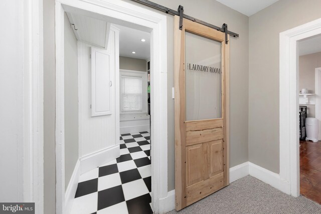 hallway featuring a barn door