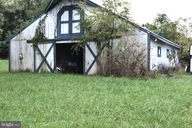 view of outbuilding with a lawn