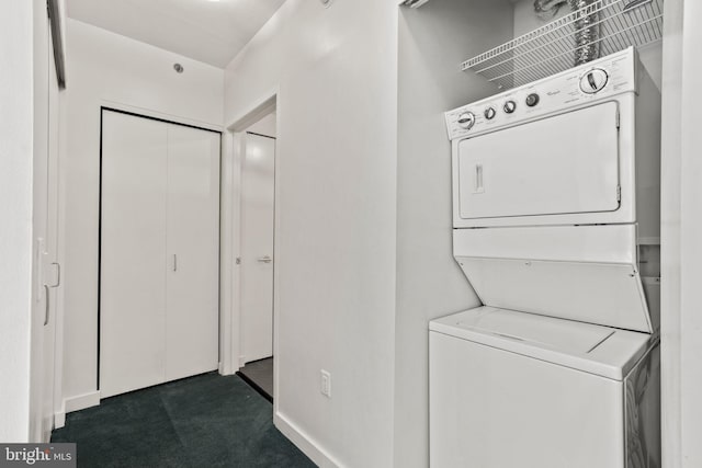 laundry area with stacked washing maching and dryer and dark colored carpet