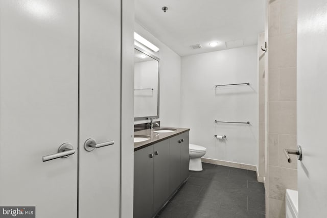 bathroom with vanity, toilet, and tile patterned floors