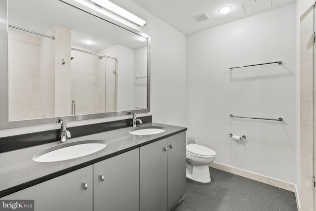 bathroom featuring walk in shower, vanity, toilet, and tile patterned floors