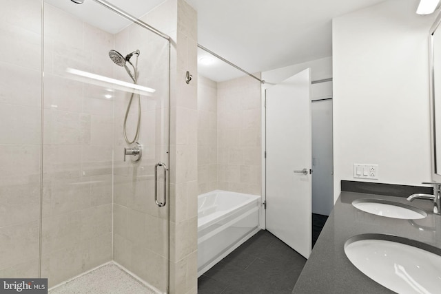 bathroom featuring vanity and separate shower and tub