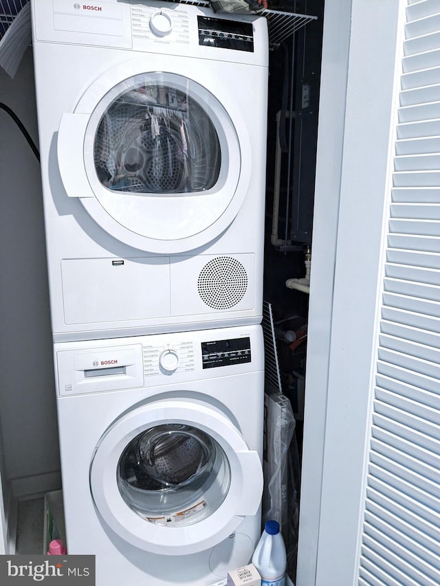 washroom featuring stacked washing maching and dryer