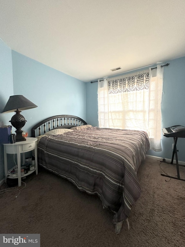 bedroom featuring dark colored carpet