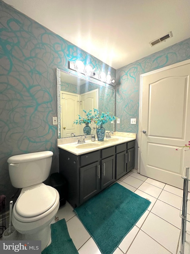 bathroom featuring vanity, tile patterned floors, and toilet