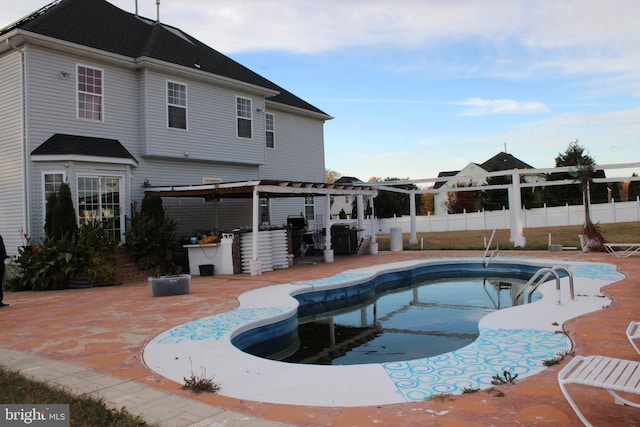 view of swimming pool featuring an outdoor bar, area for grilling, and a patio area