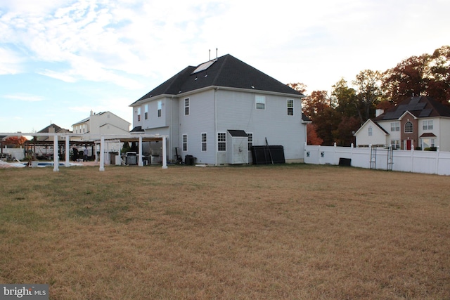 rear view of property featuring a yard