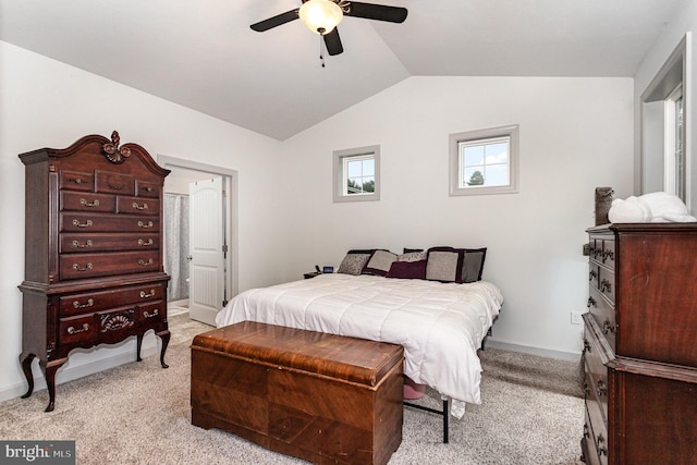 carpeted bedroom featuring vaulted ceiling, ceiling fan, and ensuite bathroom