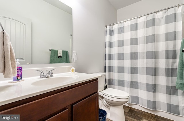 bathroom featuring hardwood / wood-style flooring, vanity, and toilet