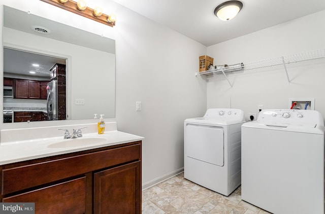 washroom featuring sink and washer and dryer