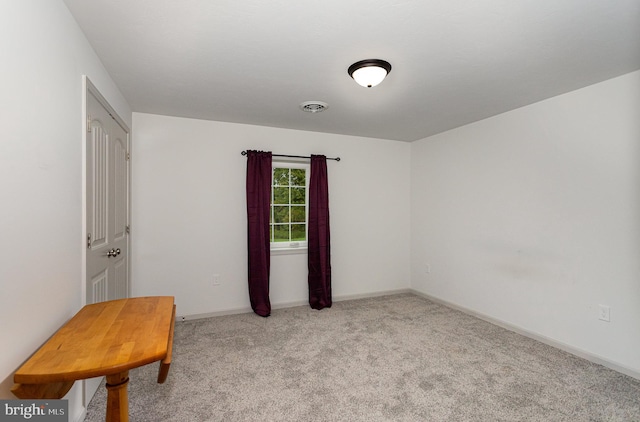 spare room with light colored carpet