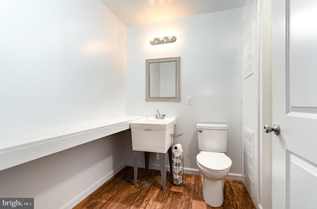 bathroom featuring hardwood / wood-style floors and toilet