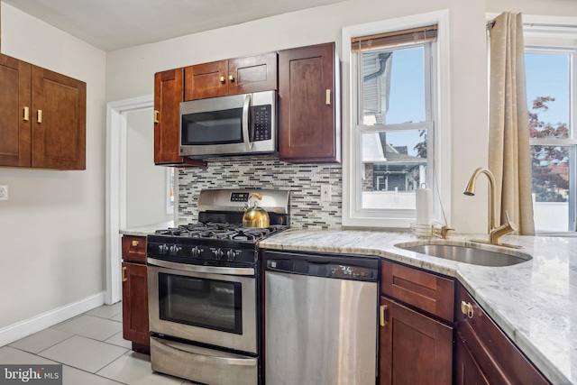 kitchen with appliances with stainless steel finishes, sink, and plenty of natural light