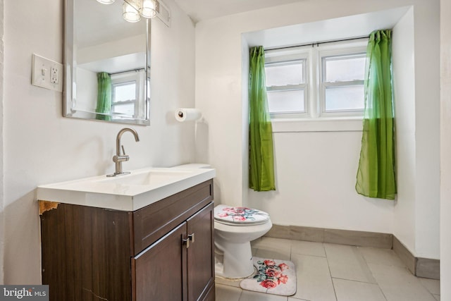 bathroom featuring vanity, toilet, and tile patterned floors