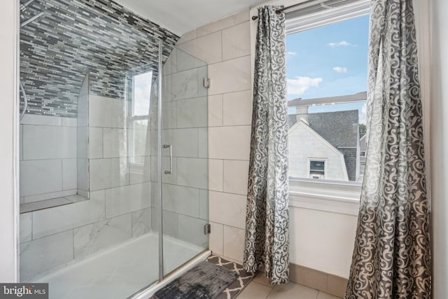 bathroom with walk in shower and tile patterned floors