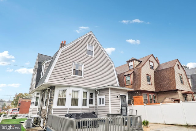 back of house featuring central AC unit