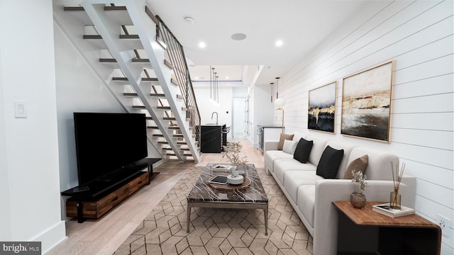 living room with sink and light wood-type flooring