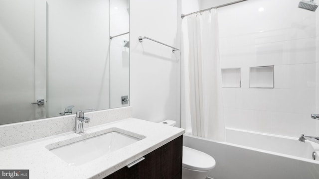 full bathroom featuring toilet, vanity, and shower / bath combination with curtain