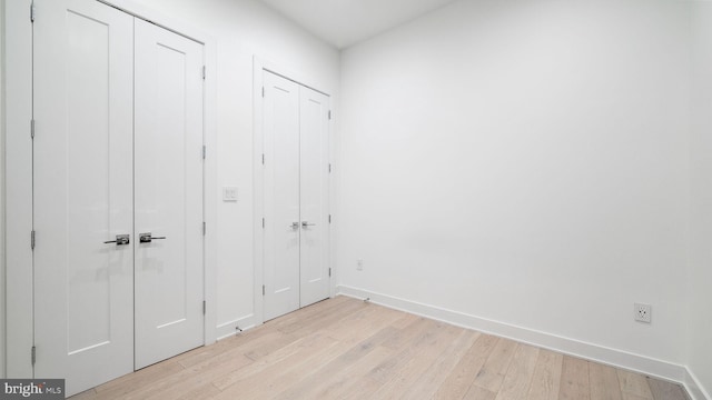 unfurnished bedroom featuring light wood-type flooring