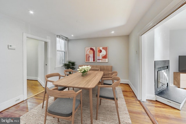 dining space with light hardwood / wood-style floors