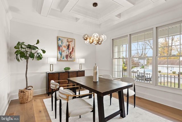 dining space featuring beam ceiling, light wood-type flooring, crown molding, and coffered ceiling