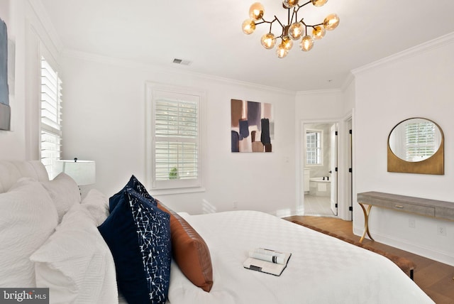 bedroom with an inviting chandelier, wood-type flooring, connected bathroom, and multiple windows