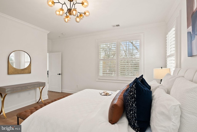 bedroom with ornamental molding, dark hardwood / wood-style floors, and a notable chandelier