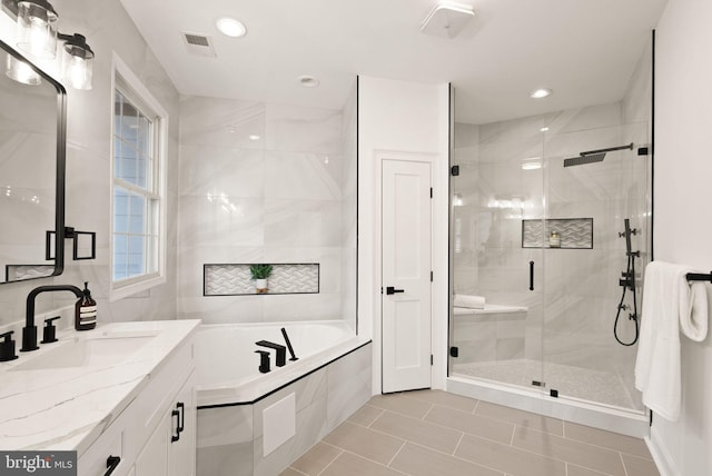 bathroom with separate shower and tub, tile patterned floors, and vanity