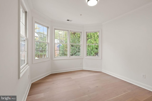 spare room with light hardwood / wood-style flooring and ornamental molding