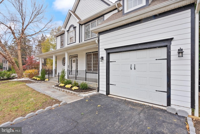 exterior space featuring a garage and covered porch