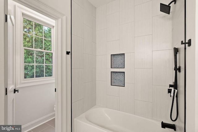 bathroom featuring tile patterned flooring and tiled shower / bath