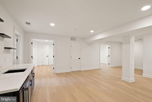 interior space featuring light wood-type flooring and sink