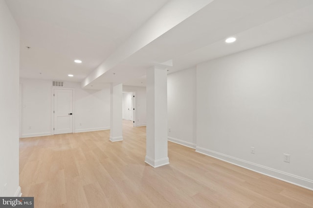 basement with light hardwood / wood-style floors